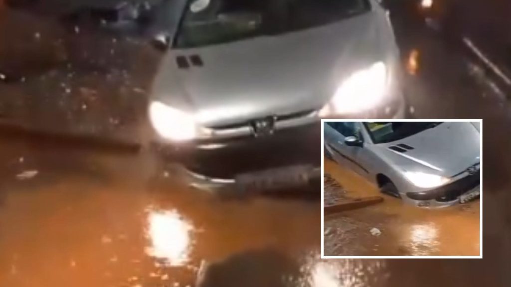 Carro cai em cratera coberta pela chuva e assusta motoristas no Centro de Cuiabá; veja vídeo